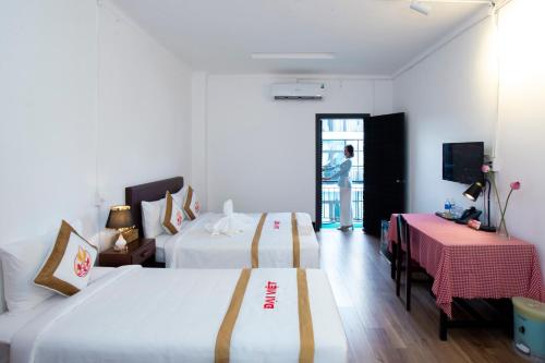 Postel nebo postele na pokoji v ubytování The Rice 131 Bui Vien Hotel
