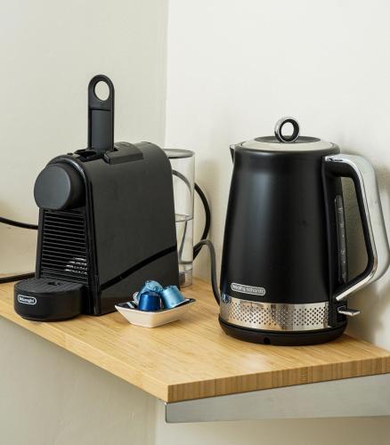 a toaster and coffee maker on a wooden shelf at Villa Ono at Bar Ilan University and Sheba Hospital in Qiryat Ono