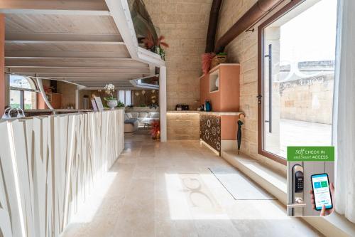 a room with a hallway with a large window at Corte Dei Granai Meeting & SPA - Raro Rooms Collection in Maglie