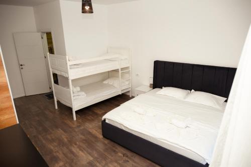 a bedroom with a bed and a white book shelf at Hotel & Restaurant Frida in Gjakove