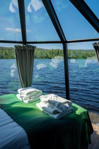 a bed on a boat on a body of water at Nova Galaxy Village in Rovaniemi