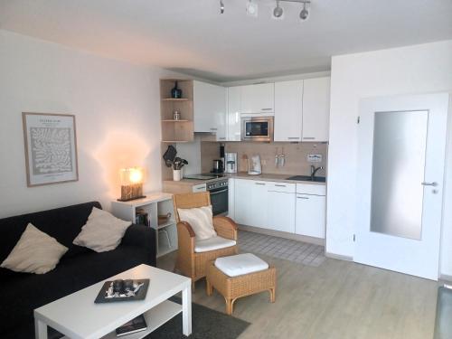 a living room with a couch and a table at Residenz Passat Cuxhaven 5 in Cuxhaven