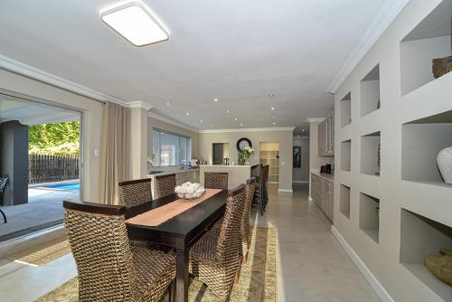 a kitchen and dining room with a table and chairs at Atlantica in Yzerfontein