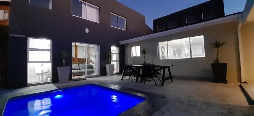 a house with a blue swimming pool in a yard at Atlantica in Yzerfontein