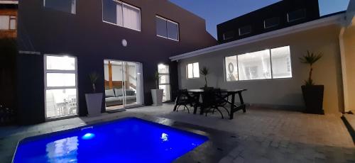 a house with a blue swimming pool in the yard at Atlantica in Yzerfontein