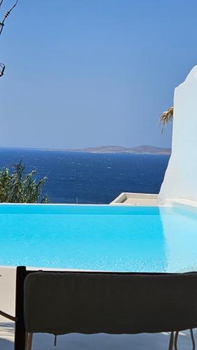 a swimming pool with a view of the ocean at ELLI TROPiCAL LUXURY SUITES SUNSET-INFINITY POOL- SEA SIDE-NEAR CENTER PARKING in Mikonos