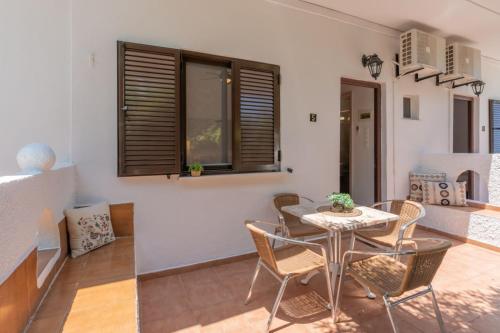 a dining room with a table and chairs at SKYROS AVRA Residences in Skiros