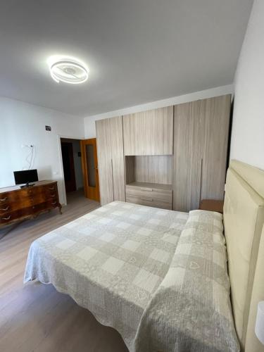 a bedroom with a large bed and a piano at Mamma Gina in Vieste