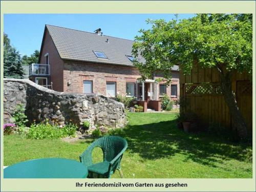 a green chair in the yard of a house at Grüne Idylle in Borrentin