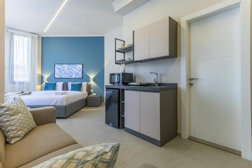 a hotel room with a bed and a room with a kitchen at CityZen - Boutique Studios in Achrafieh in Beirut