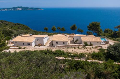 a group of houses on a hill near the ocean at Costa Mediterranea in Gaios