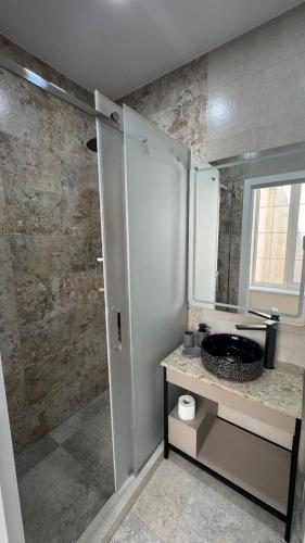 a bathroom with a sink and a mirror at Deribas Apartments in Odesa