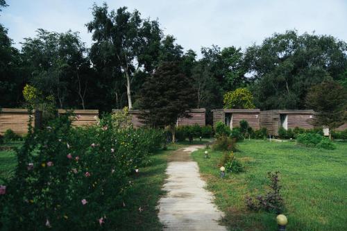 a garden with a path in the grass at Chong khaep aingkwai resort Saiyok in Sai Yok