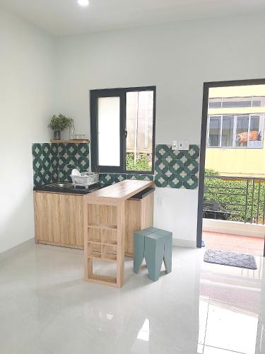 a kitchen with a wooden counter and a window at LENA Home in Da Lat
