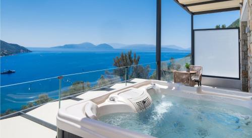 a jacuzzi tub with a view of the ocean at Azzura villas in Vasiliki
