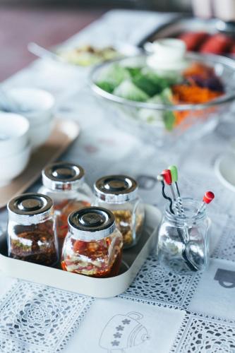 a tray of jars of pickles on a table at Chong khaep aingkwai resort Saiyok in Sai Yok