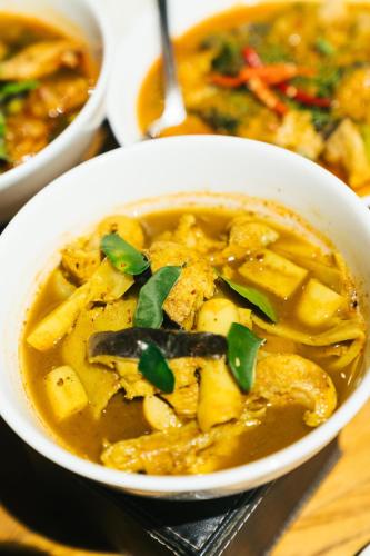 a white bowl of soup with vegetables in it at Chong khaep aingkwai resort Saiyok in Sai Yok