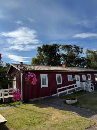 a red house with flowers in front of it at Solstickan Hotell & Vandrarhem in Mellbystrand