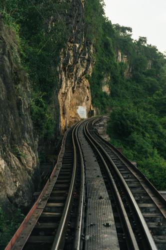 a set of train tracks going through a mountain at Chong khaep aingkwai resort Saiyok in Sai Yok