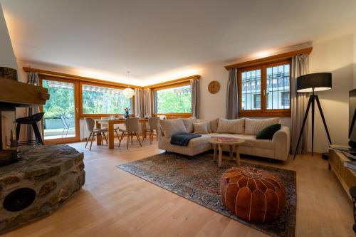 a living room with a couch and a fireplace at Exclusive Glacier View Apartment 1-4 Pers in Klosters