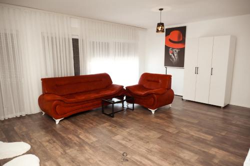 a living room with two chairs and a couch at Hotel & Restaurant Frida in Gjakove