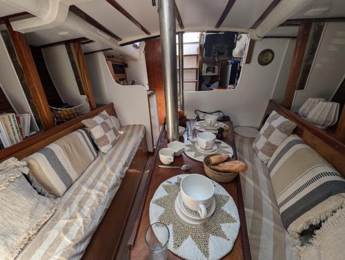 a living room with two couches and a table at Séjour insolite à bord d'un voilier de 11m - Charmante Marina proche Barcelone in Sitges