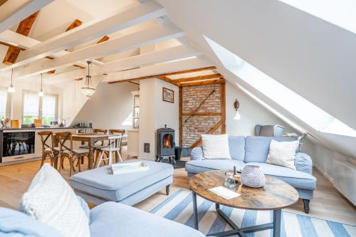 a living room with a couch and a table at Altes Tagelöhner Haus - Whg 1 in Pudagla