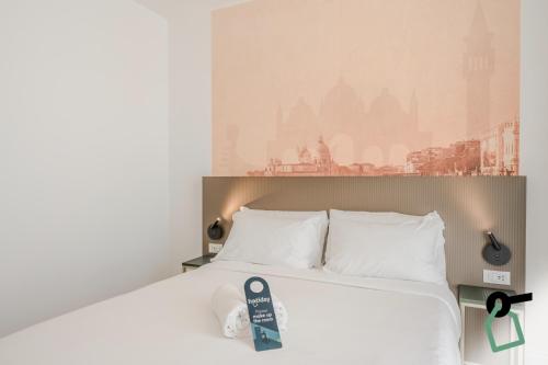 a bedroom with a bed with white pillows at Hotiday Venezia Tronchetto in Venice
