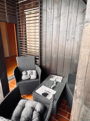 a room with two chairs and a table and a table and chairsuggest at Ferienwohnung in der nähe von Europapark Kehl in Kehl am Rhein