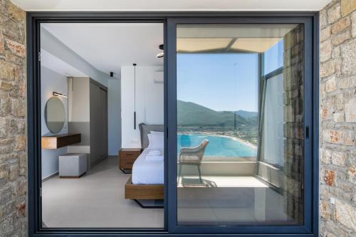 a room with a sliding glass door leading to a bedroom at Azzura villas in Vasiliki