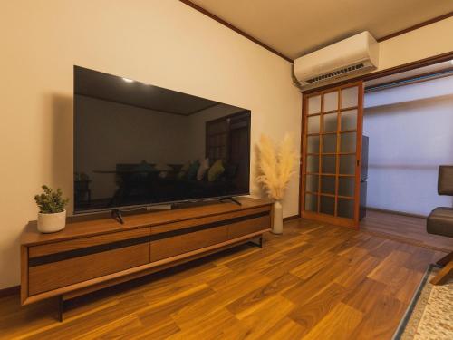 a living room with a large flat screen tv at 松江和結庵 in Matsue