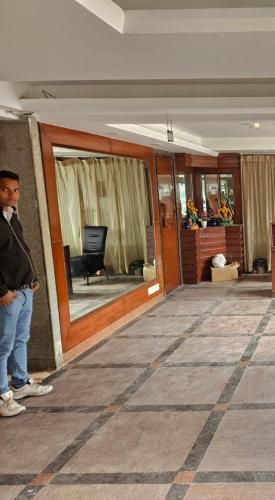 a man standing in front of a building at Hotel Krishna Land in New Delhi