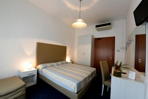 Postel nebo postele na pokoji v ubytování Hotel Savoia