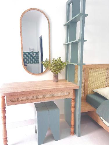 a dressing table with a mirror and a shelf at LENA Home in Da Lat
