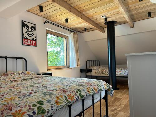 a bedroom with a bed in a room at Rogaty Dworek in Kornatka