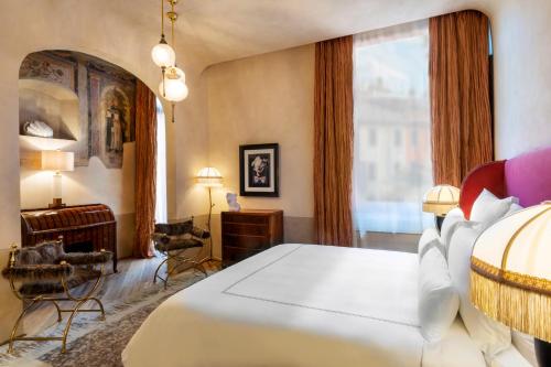 a bedroom with a white bed and a large window at The James Suite Hotel Firenze 1564 - Small Luxury Hotels of the World in Florence