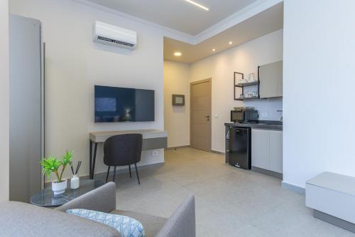 a living room with a table and a kitchen at CityZen - Boutique Studios in Achrafieh in Beirut