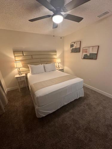 a bedroom with a large bed with a ceiling fan at Sunset Serenity in Las Vegas