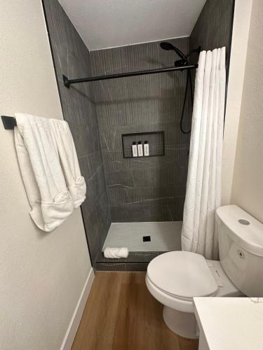 a small bathroom with a toilet and a shower at Sunset Serenity in Las Vegas
