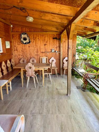 a wooden dining room with a wooden table and chairs at Ubytování Malý RETRO Sklípek in Krumvíř