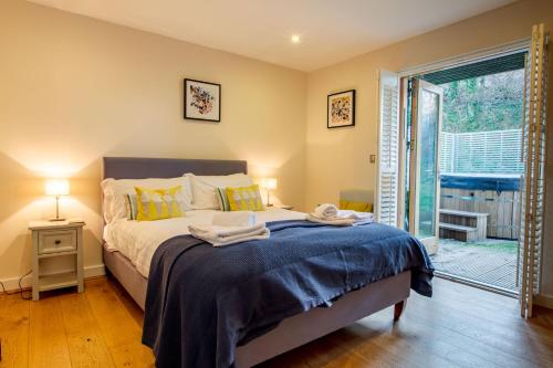 a bedroom with a bed with towels on it at House 30 in Looe