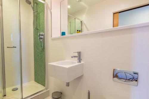 a bathroom with a sink and a shower at House 30 in Looe
