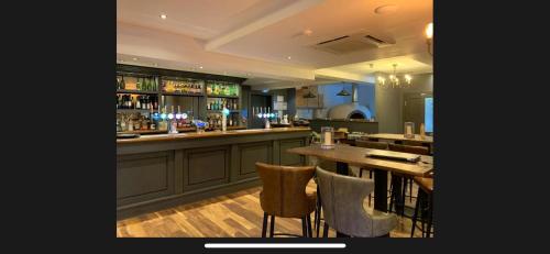 a bar with a table and chairs in a restaurant at JaBry Beach House Filey in Filey