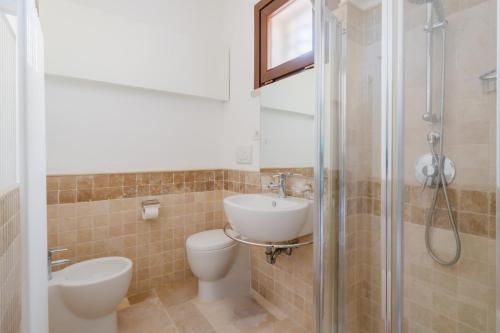 a bathroom with a sink and a toilet and a shower at L`Oasi del Mare by BarbarHouse in Torre rinalda