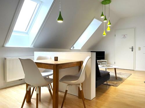 a dining room with a table and white chairs at Hof Hanau in Dörgenhausen