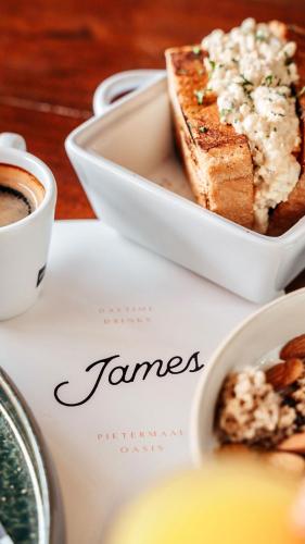 a plate with a bowl of bread and a cup of coffee at Pietermaai Boutique Hotel in Willemstad