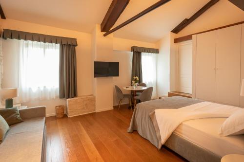 a bedroom with a large bed and a table at Castello di Porcìa - Residence Agrituristico in Porcia