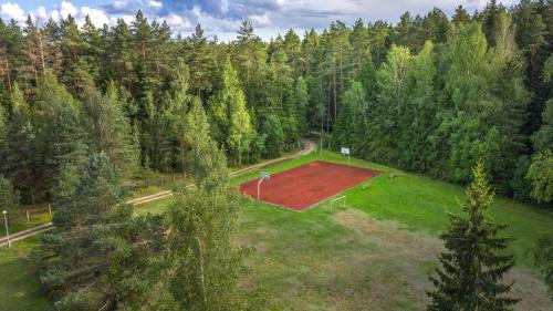an aerial view of a soccer field in a forest at Poilsio kompleksas Tolieja Vieta renginiams bei poilsiui ant ežero kranto in Kulionys
