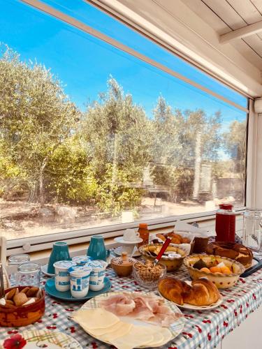 a table with food on it with a window at Agape B&B Monopoli in Monopoli