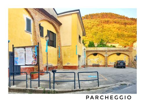 a parking lot next to a building with a car at A casa dei nonni in San Felice a Cancello